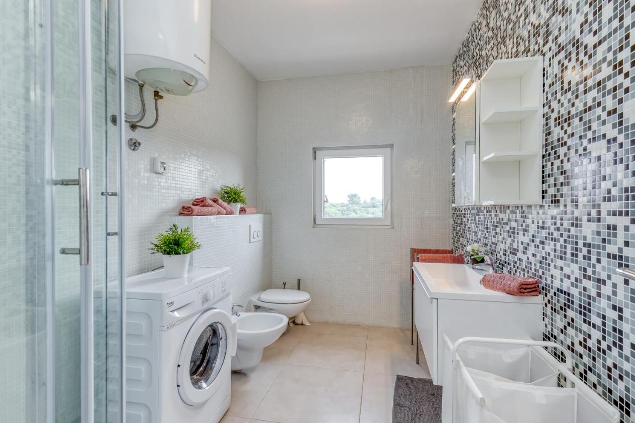 Bathroom with sink, toilet, and washing machine