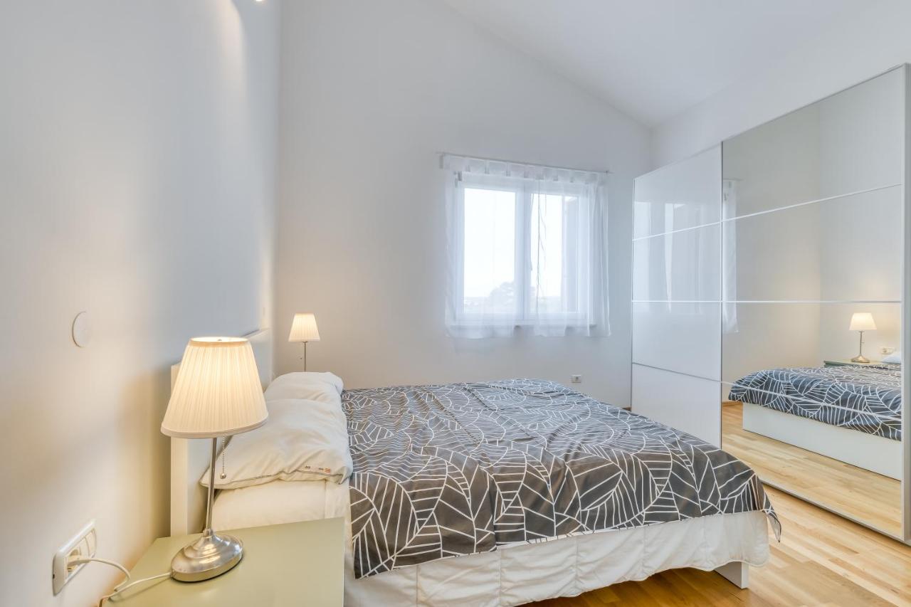 White bedroom with double bed at Diamond Seaview Penthouse