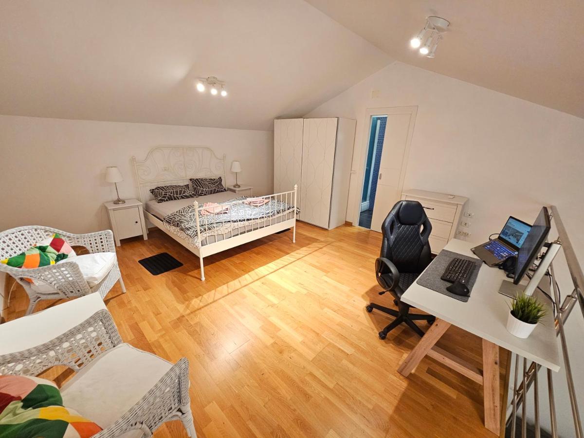Bedroom with work desk, monitor, and chair