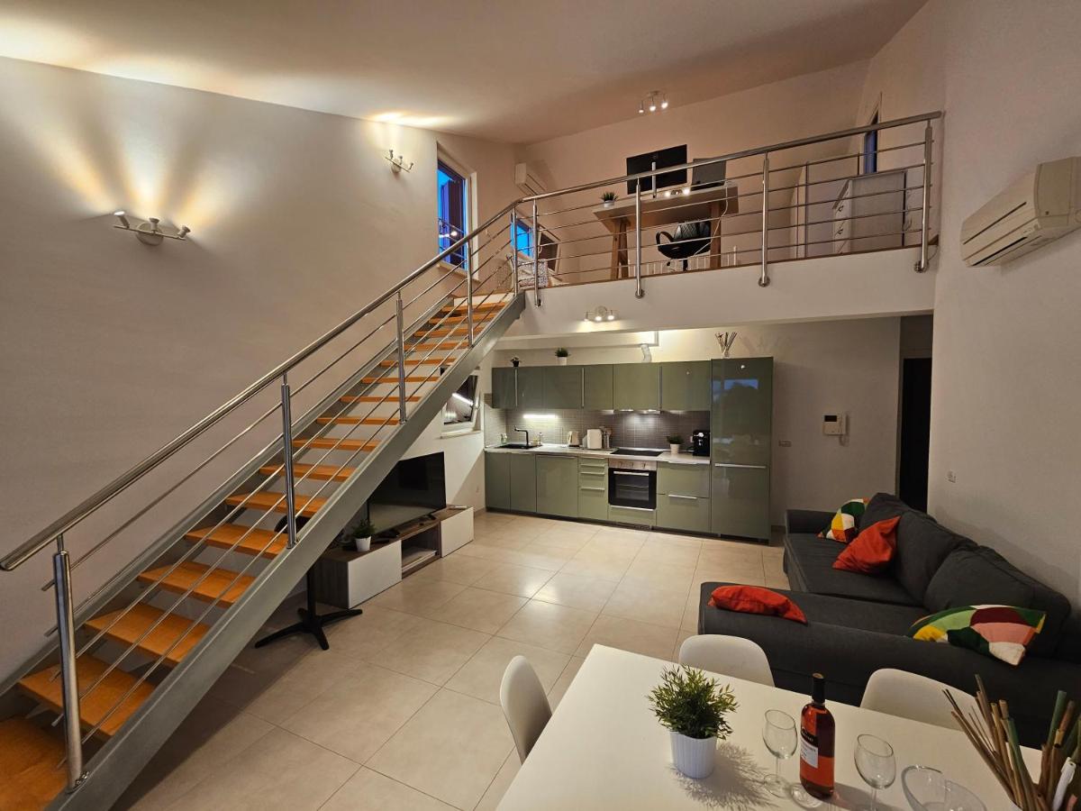 Open-plan living room with staircase leading toward the kitchen