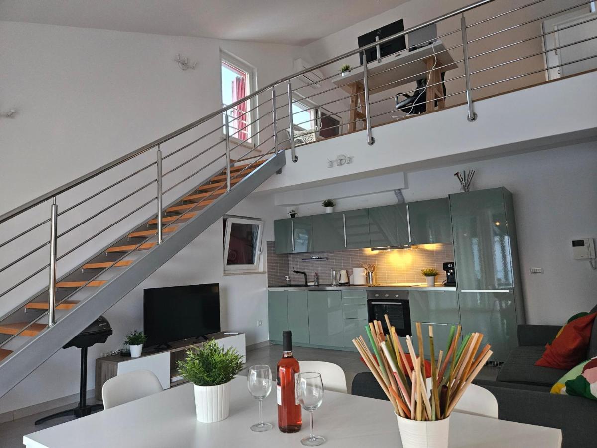 Living room with staircase at Diamond Seaview Penthouse