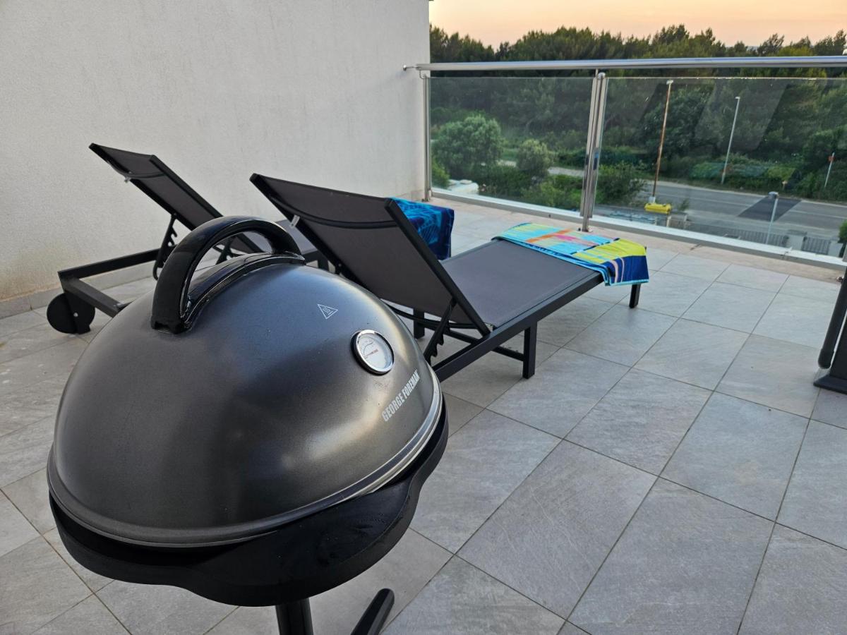 Terrace with barbecue grill and lounge chairs