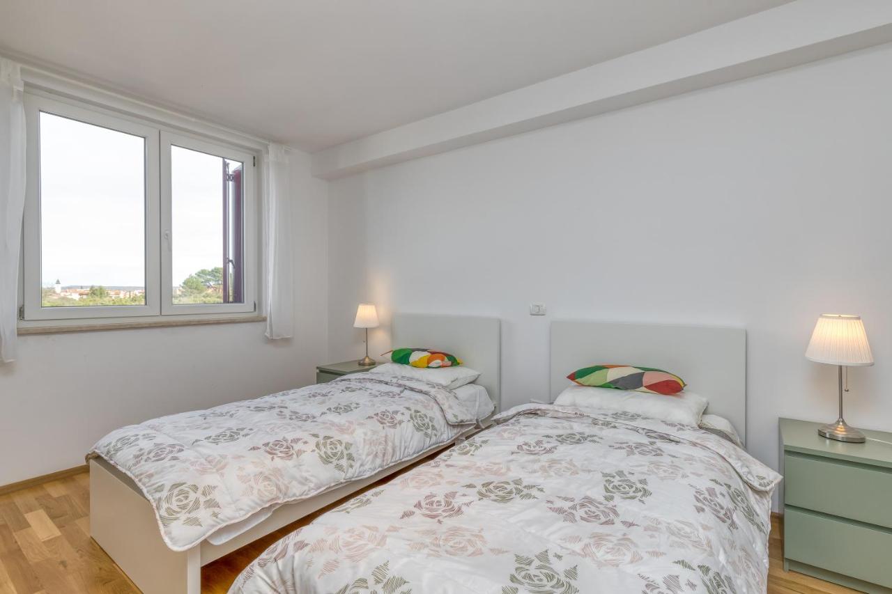 Twin bedroom with two beds and windows